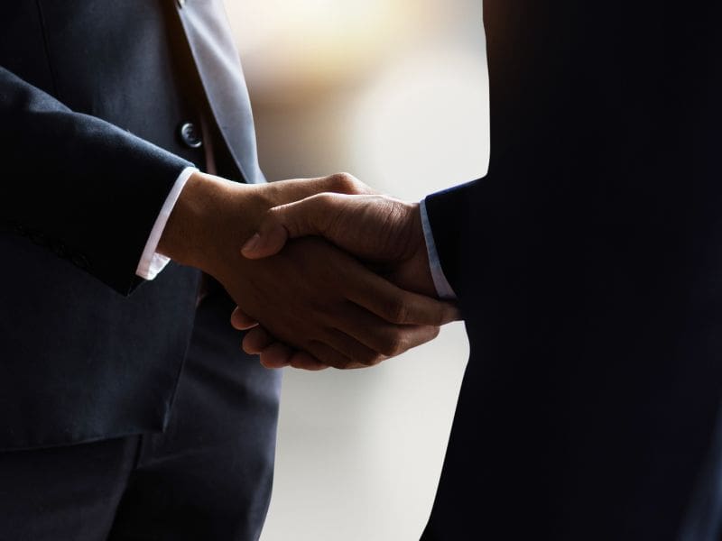 Business professionals collaborating with third-party partners on a digital device. My Tampa IT helps manage and secure relationships with third-party business partners.
